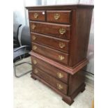 A HARDWOOD CHEST ON CHEST OF DRAWERS