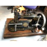 A VINTAGE CASED SEWING MACHINE