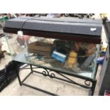 A FISH TANK WITH ACCESSORIES ON A WROUGHT IRON STAND