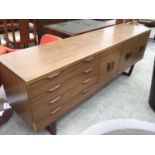 A RETRO VENEREED SIDEBOARD WITH DRAWERS AND DOORS