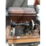 A VINTAGE VIBRA SEWING MACHINE IN A WOODEN CARRY CASE