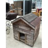 A WOODEN DOG KENNEL