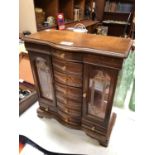 A SMALL TABLE TOP CABINET