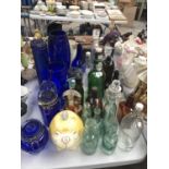 A LARGE COLLECTION OF GLASS BOTTLES, JARS AND VASES ETC