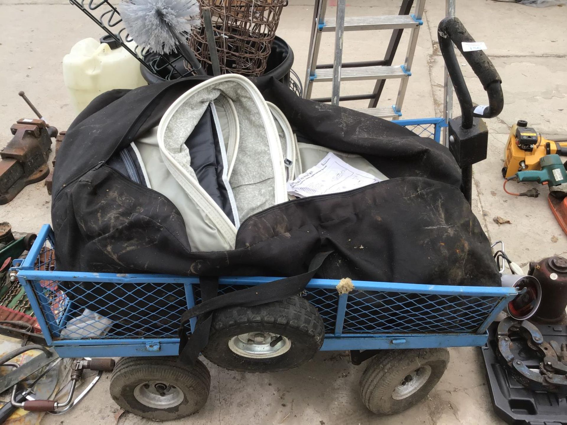 A METAL FOUR WHEELED TROLLEY AND A ALL IN ONE 420 CARAVAN AWNING