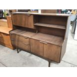 A RETRO TEAK SIDEBOARD WITH TWO LOWER DOORS AND DRAWERS AND AN UPPER FALL FRONT DOOR