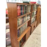 TWO RETRO 'MINTY' SLIDING DOOR BOOKCASES WITH UPPER GLAZED PANELS, TOGETHER WITH A LARGE QUANTITY OF