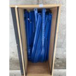 A WOODEN BOX CONTAINING BLUE METAL SHOP RACK FITTINGS