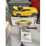 A YELLOW SPORTS CAR DVD MPEG 4 PLAYER WITH REMOTE CONTROL, INSTRUCTIONS, AND LEADS