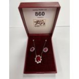 A BOXED PAIR OF EARRINGS AND NECKLACE WITH RUBY STONES