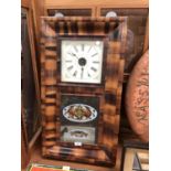 A LARGE WOODEN WALL CLOCK WITH GLASS CASE