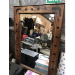 A LARGE WOODEN FRAMED ARTS AND CRAFTS MIRROR