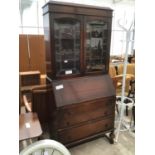 AN OAK DISPLAY BUREAU BOOKCASE WITH UPPER GLAZED DOORS