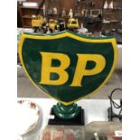 A LARGE METAL 'BP' SIGN ON BASE