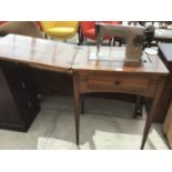 A VINTAGE MAHOGANY SINGER SEWING MACHINE TABLE