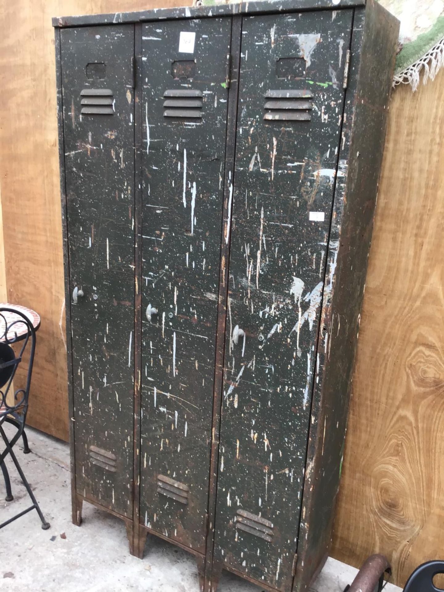 A VINTAGE THREE CUPBOARD METAL LOCKER UNIT