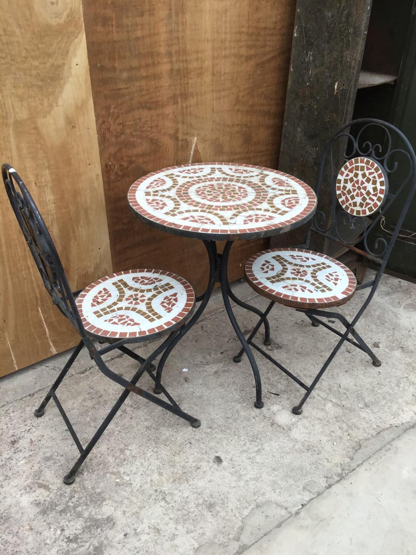 A DECORATIVE BISTRO TABLE AND TWO CHAIRS SET