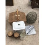 A WICKER PICNIC BASKET WITH ENAMEL BREAD BIN AND JUG, TWO STONEWARE JARS, A MARBLE CHOPPING BOARD