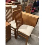 A MODERN DINING TABLE AND FOUR CHAIRS