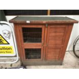 A TWO STOREY RABBIT HUTCH WITH A RAMP BETWEEN UPPER AND LOWER FLOORS