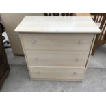 A MODERN CHEST OF THREE DRAWERS