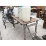 A VINTAGE WOODEN TRESTLE TABLE WITH VARIOUS PLASTIC BREWING BUCKETS AND BARRELS