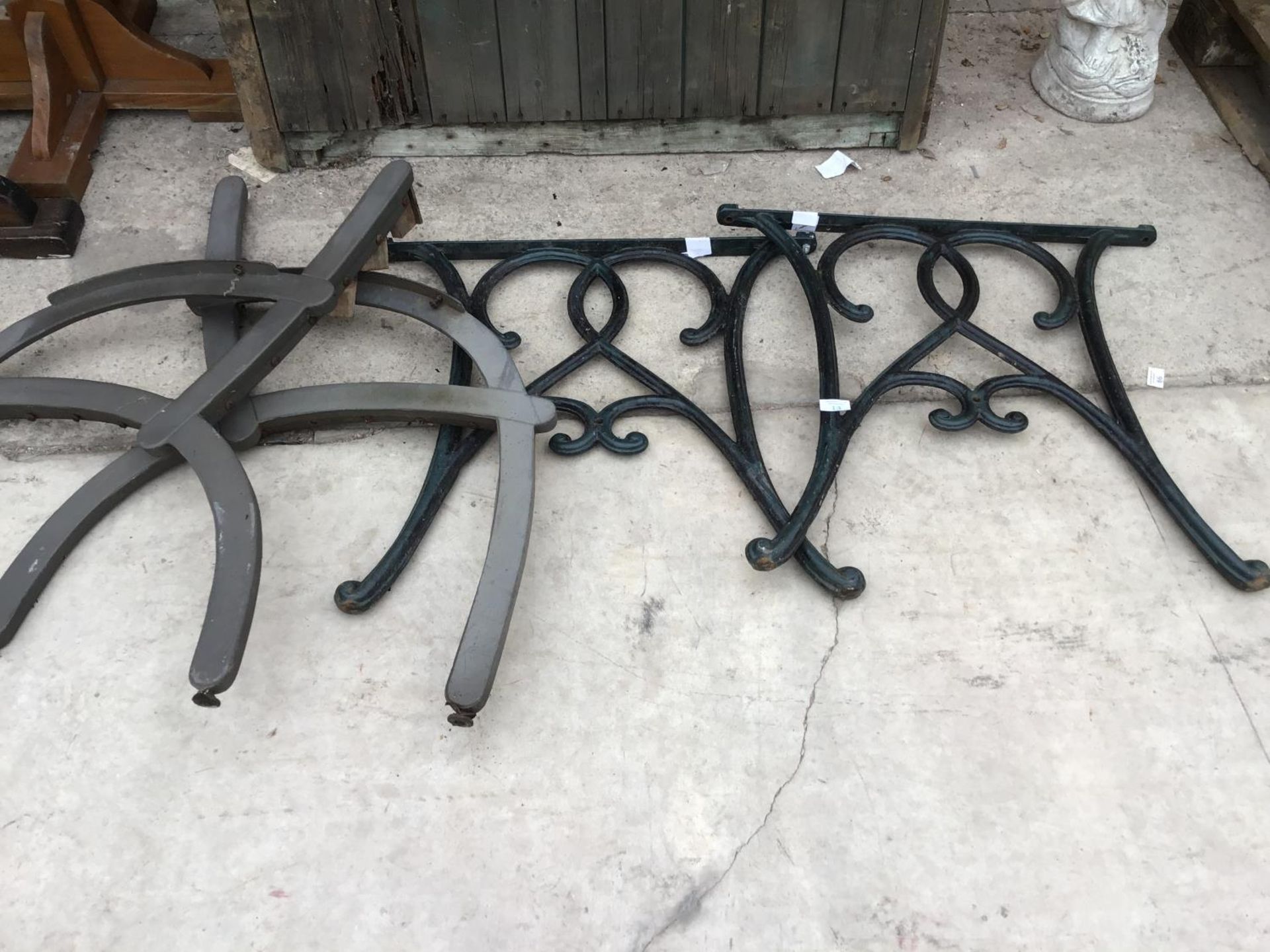 A PAIR OF CAST IRON BENCH ENDS AND A PAIR OF MODERN BENCH ENDS