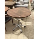 A RETRO CIRCULAR TOPPPED TABLE WITH CHROME BASE