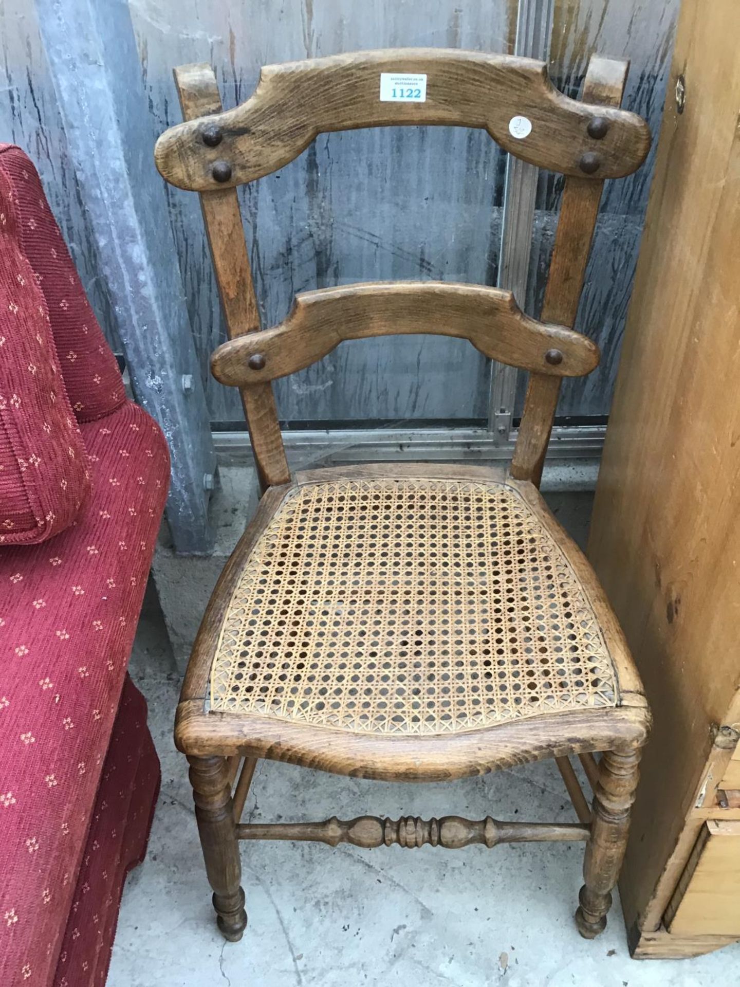A VINTAGE OAK CHAIR WITH RATTAN SEAT