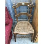 A VINTAGE OAK CHAIR WITH RATTAN SEAT