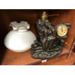 A RESIN FIGURE AND CLOCK TOGETHER WITH LAMP