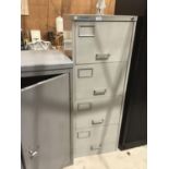 A METAL FOUR DRAWER FILING CABINET