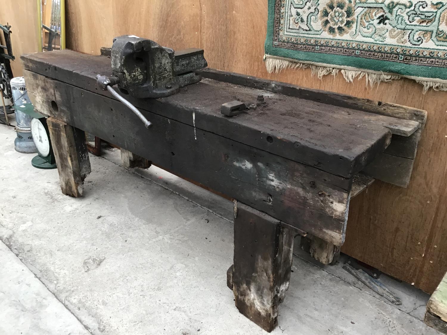 A VINTAGE PINE WORK BENCH WITH LARGE BENCH VICE