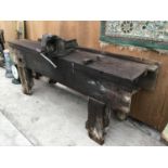 A VINTAGE PINE WORK BENCH WITH LARGE BENCH VICE