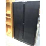 A BLACK OFFICE CABINET WITH ROLLER DOORS