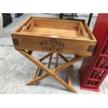 A GRADUATED SET OF WOODEN 'SOUTHERN COMFORT' TRAYS ON WOODEN STAND