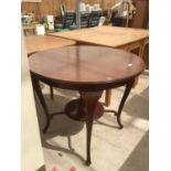 A MAHOGANY CIRCULAR TABLE WITH LOWER SHELF