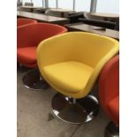 A RETRO YELLOW FABRIC SWIVEL TUB CHAIR IN CIRCULAR CHROME SUPPORT