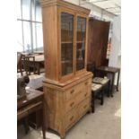 A PINE DRESSER WITH UPPER GLAZED DOORS AND LOWER DRAWERS