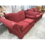 A THREE PIECE RED UPHOLSTERED SUITE WITH DROP DOWN ENDS