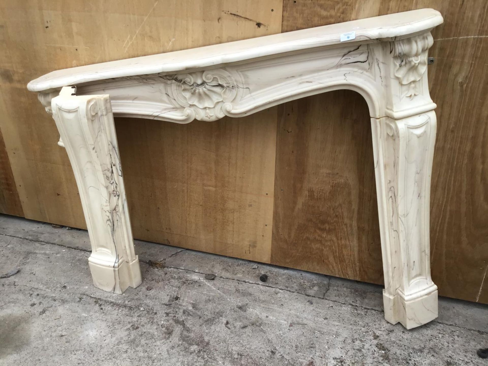 A DECORATIVE MARBLE EFFECT FIRE PLACE SURROUND