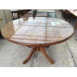 A CIRCULAR OREGAN PINE DINING TABLE WITH GLASS TOP