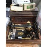 A WOODEN CASED SINGER SEWING MACHINE WITH SINGER BUTTONHOLE ATTACHMENT
