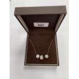 A BOXED LADIES 9CT GOLD NECKLACE WITH THREE CHARMS