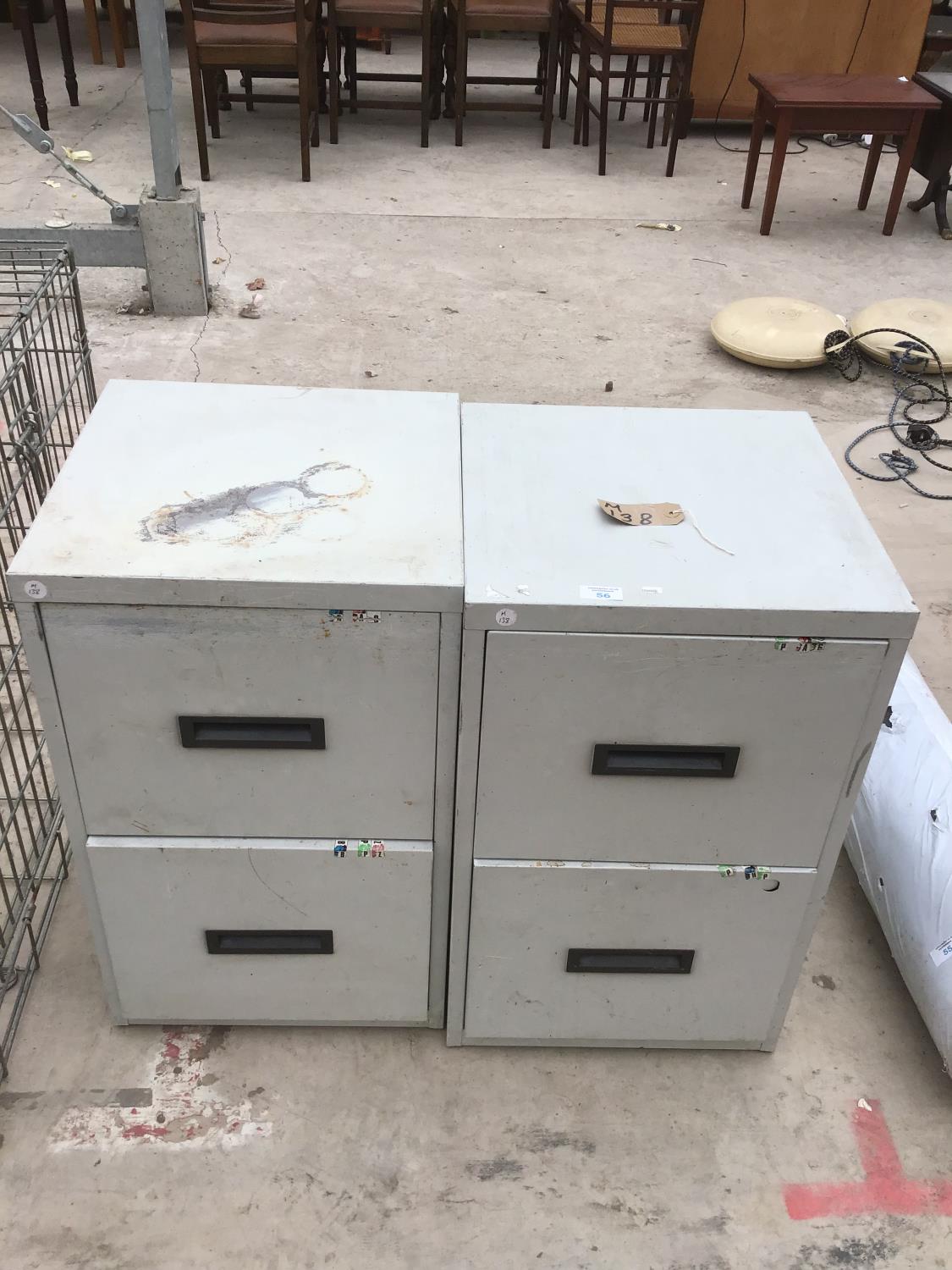 A PAIR OF METAL TWO DRAWER FILING CABINETS