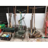 A LARGE COLLECTION OF VINTAGE GARDENING TOOLS TO INCLUDE SHEARS, MOWERS, SPADES ETC