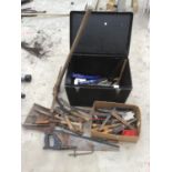 A TOOL BOX CONTAINING VARIOUS TOOLS TO INCLUDE A PICKAXE, SAWS, SHEARS, RASPS ETC