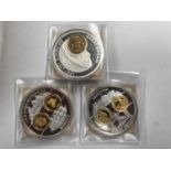 A SELECTION OF THREE LARGE COINS , EACH DEPICTING VARIOUS COINS OF THE WORLD . EACH HAS THE COA