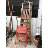 TWO VINTAGE WOODEN FOUR STEP LADDERS AND A METAL TWO STEP LADDER