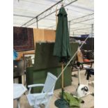A GREEN PARASOL WITH COVER COMPLETE WITH GREEN CAST IRON BASE